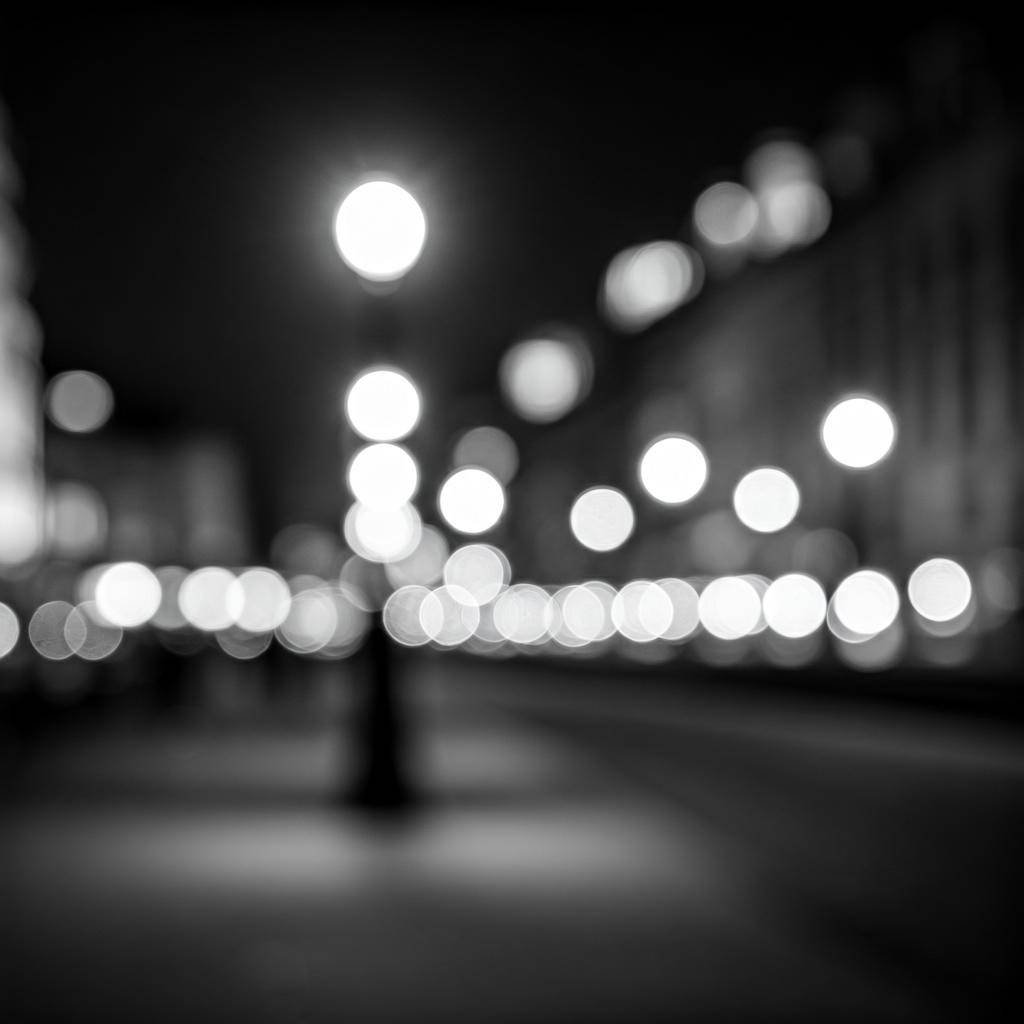Black and white city street with blurred lights